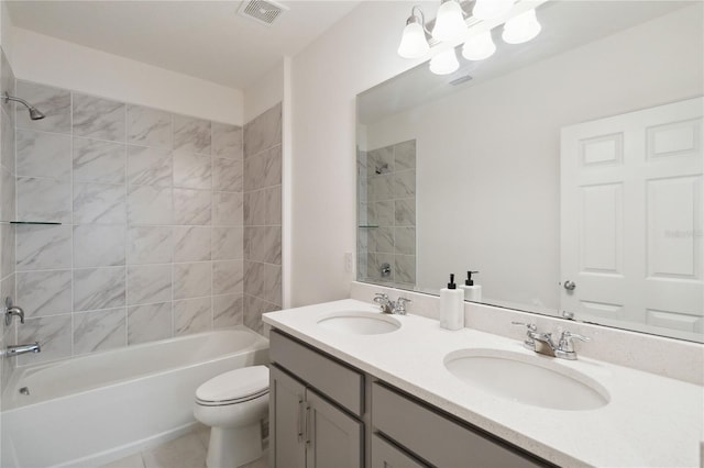 full bathroom with tile patterned flooring, vanity, toilet, and tiled shower / bath