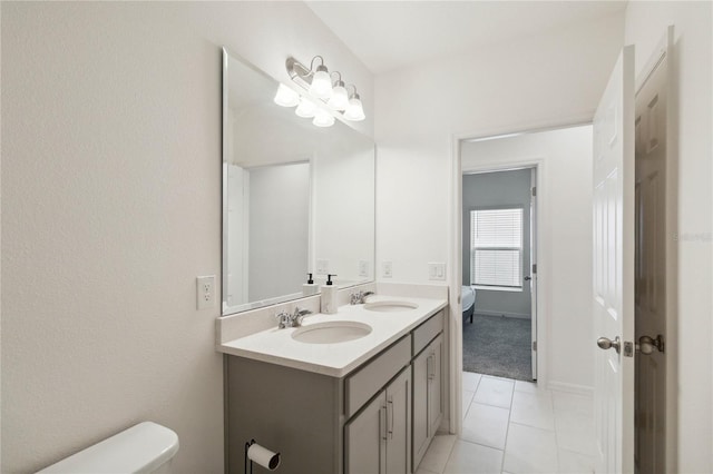 bathroom with vanity, tile patterned flooring, and toilet