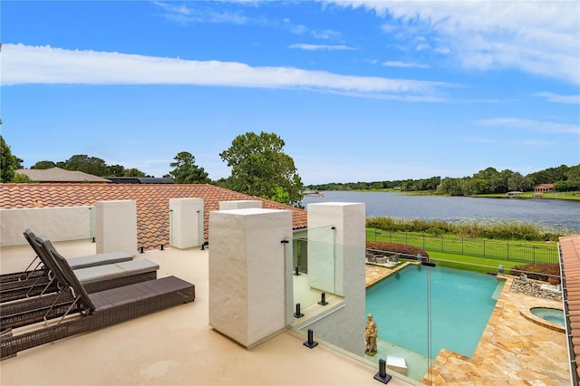 view of swimming pool featuring a fenced in pool, a water view, a patio, and fence