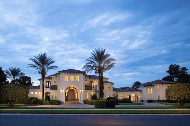 mediterranean / spanish house featuring stucco siding