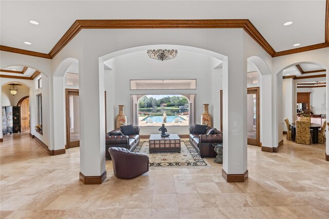 interior space featuring recessed lighting, crown molding, arched walkways, and baseboards