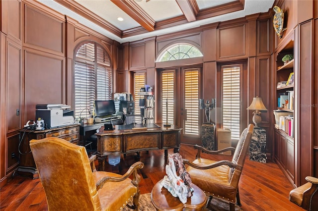 office area with coffered ceiling, dark wood-type flooring, crown molding, a decorative wall, and beam ceiling