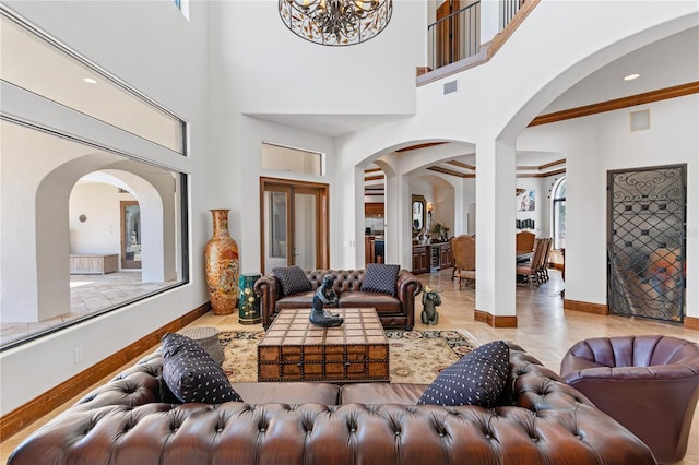 living room with a chandelier, visible vents, and baseboards