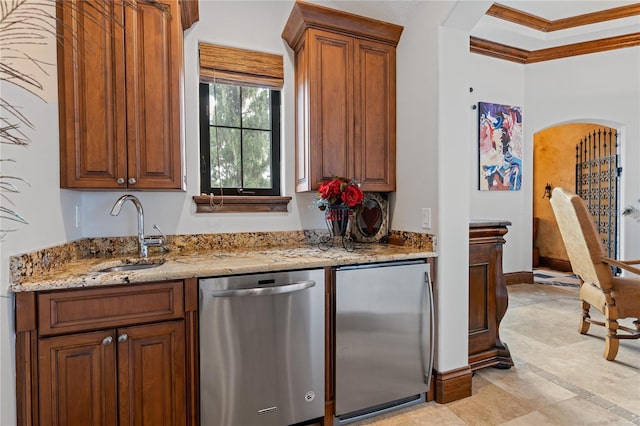 kitchen with arched walkways, stainless steel appliances, a sink, light stone countertops, and crown molding