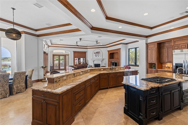 kitchen with open floor plan, a large island, light stone countertops, and stainless steel built in fridge