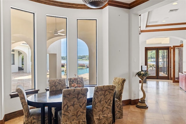 dining space featuring crown molding, light tile patterned floors, visible vents, a high ceiling, and an AC wall unit