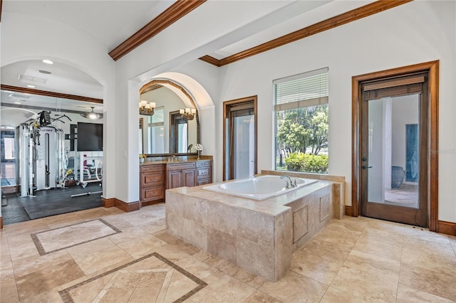 full bathroom featuring baseboards, a bath, vanity, and crown molding