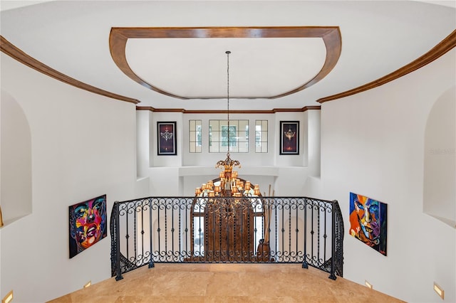 hall featuring an inviting chandelier, arched walkways, and ornamental molding