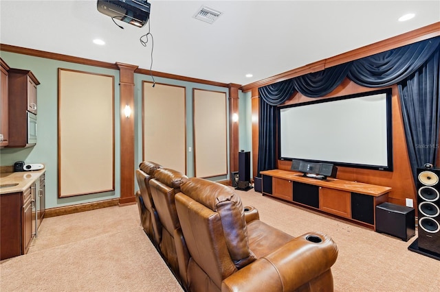 home theater with recessed lighting, light colored carpet, crown molding, and visible vents