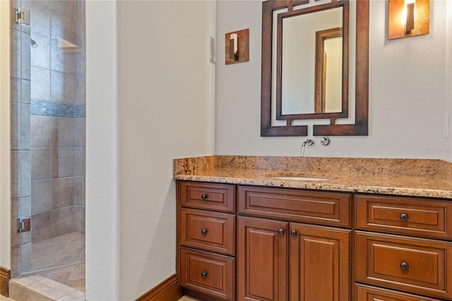 full bathroom with a shower stall and vanity