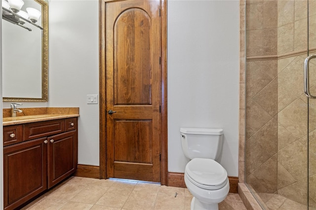 bathroom featuring toilet, a stall shower, tile patterned flooring, and vanity