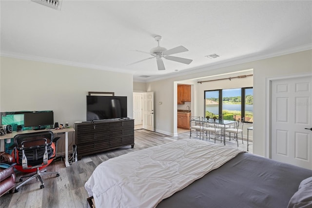 bedroom featuring light wood-type flooring, access to outside, visible vents, and crown molding