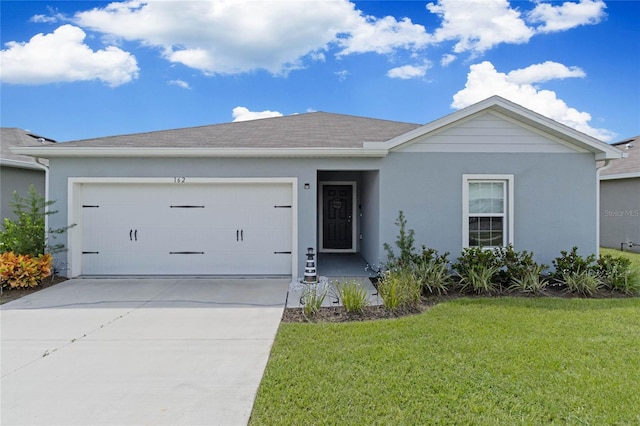 ranch-style house with a garage and a front lawn