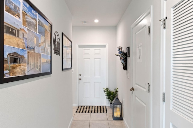 doorway with light tile patterned flooring