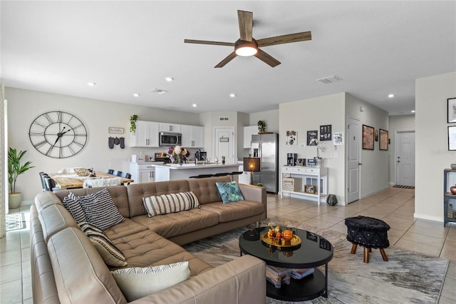 tiled living room featuring ceiling fan