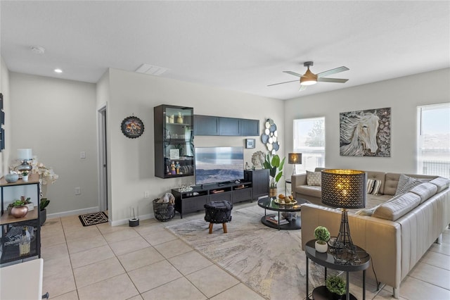 living room with ceiling fan and light tile patterned floors