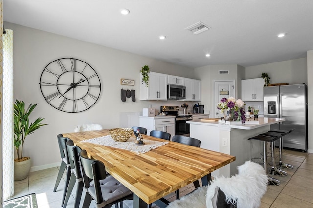 dining space with light tile patterned floors