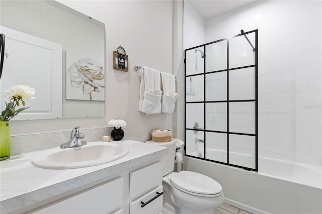 full bathroom featuring enclosed tub / shower combo, vanity, toilet, and tile patterned floors