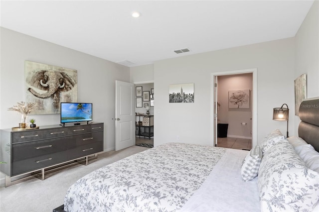 carpeted bedroom with ensuite bath