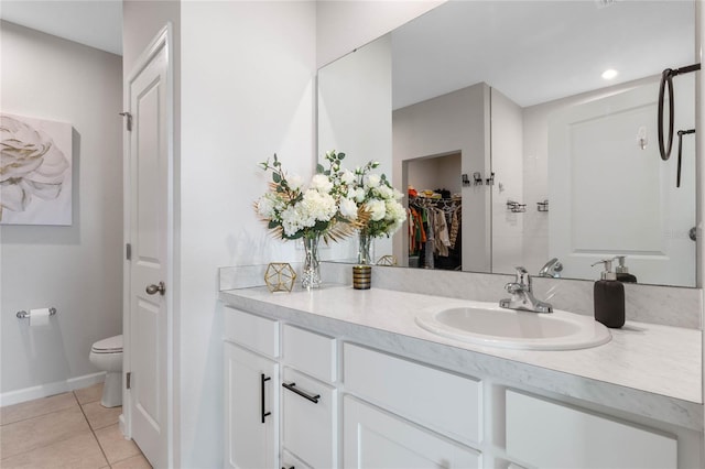 bathroom featuring tile patterned floors, vanity, and toilet