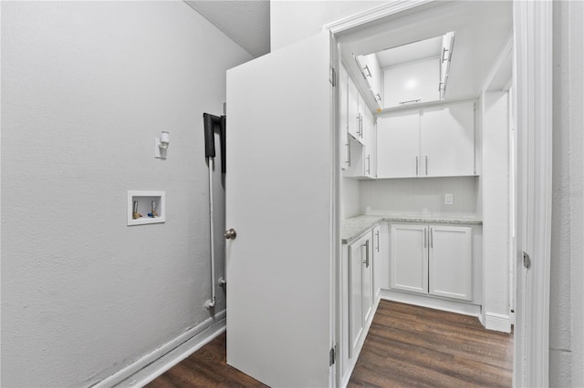 interior space featuring hookup for a washing machine, cabinets, and dark hardwood / wood-style floors