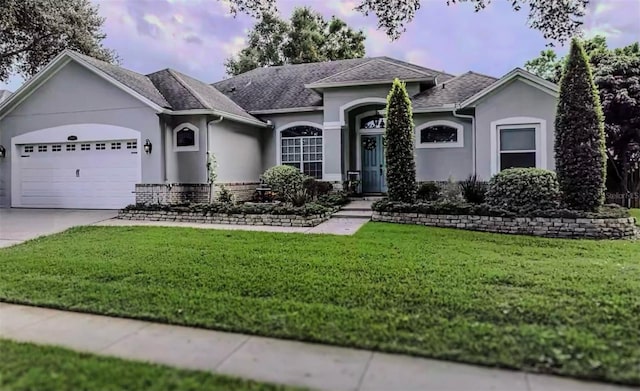 ranch-style home with a garage and a front yard