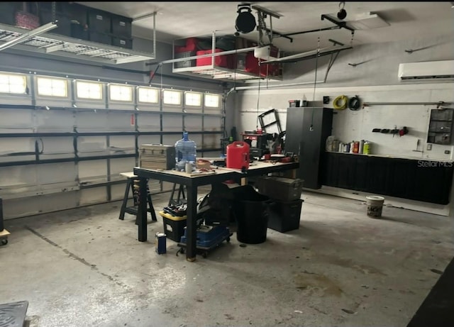 garage featuring a wall mounted AC, a workshop area, and stainless steel refrigerator