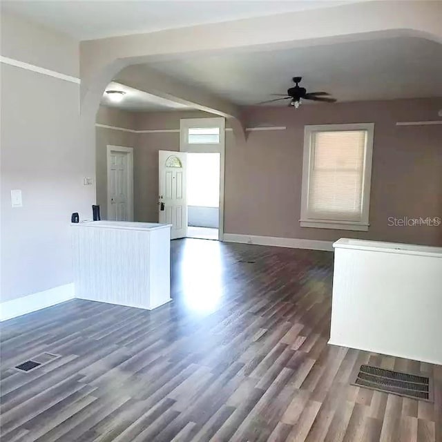 spare room featuring dark hardwood / wood-style flooring, a healthy amount of sunlight, and ceiling fan