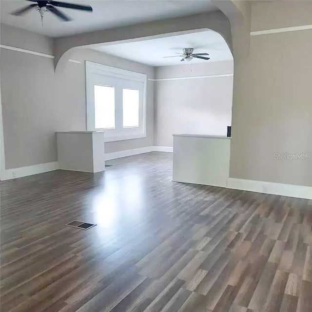 empty room featuring ceiling fan and dark hardwood / wood-style floors