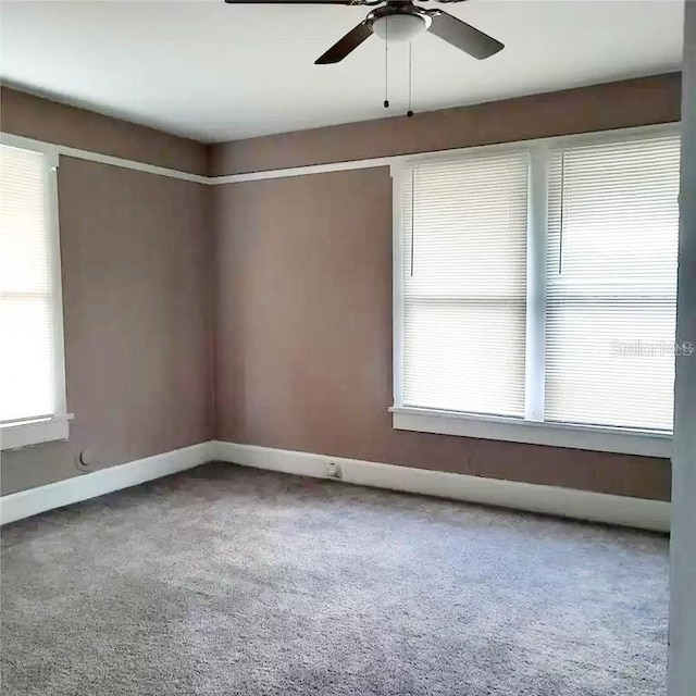 carpeted empty room featuring ceiling fan