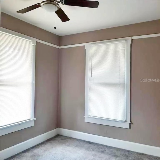 unfurnished room with a healthy amount of sunlight and ceiling fan