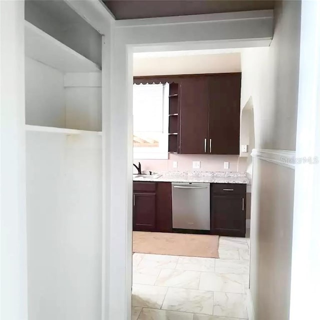 kitchen with dishwasher, sink, and dark brown cabinetry