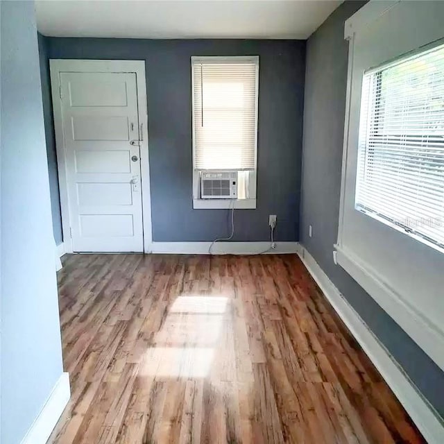 spare room featuring cooling unit and light hardwood / wood-style floors