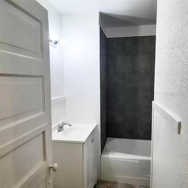 bathroom featuring shower / bathtub combination and vanity