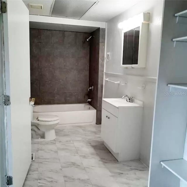 full bathroom featuring vanity, toilet, and tiled shower / bath combo