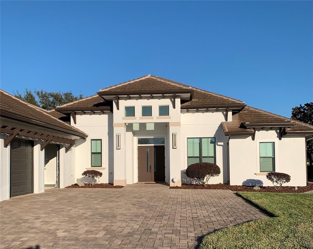 back of property with a garage