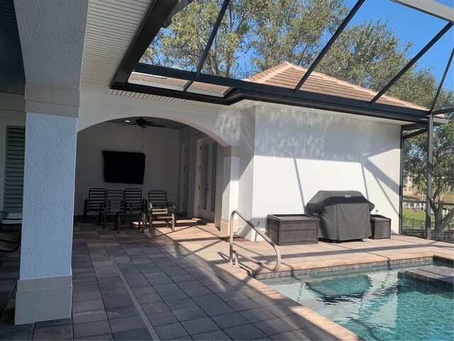 rear view of property with ceiling fan and a patio