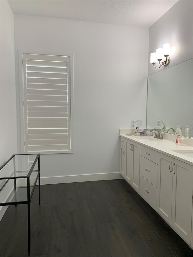 bathroom with hardwood / wood-style floors, vanity, and a textured ceiling