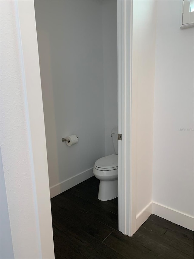 bathroom with wood-type flooring and toilet