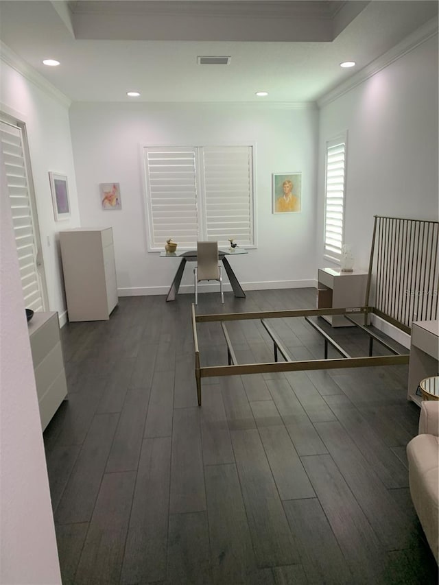 interior space featuring dark wood-type flooring and ornamental molding