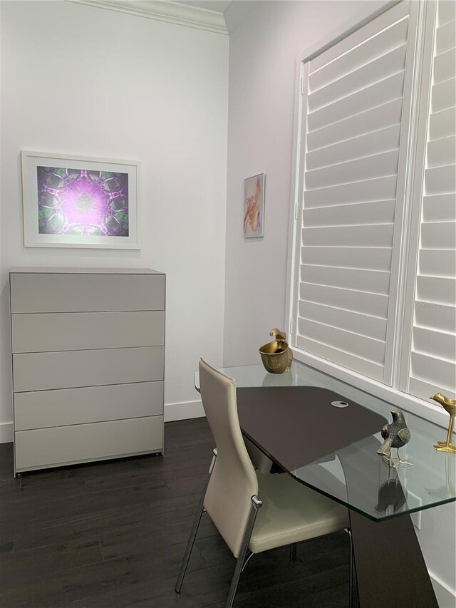 dining room with dark wood-type flooring and ornamental molding