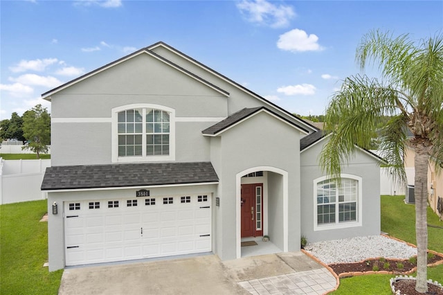 view of front of house featuring a garage and a front lawn