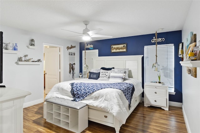 bedroom featuring dark wood-type flooring, multiple windows, and ceiling fan