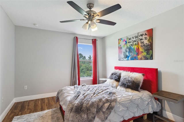 bedroom featuring ceiling fan, a textured ceiling, and dark wood-type flooring