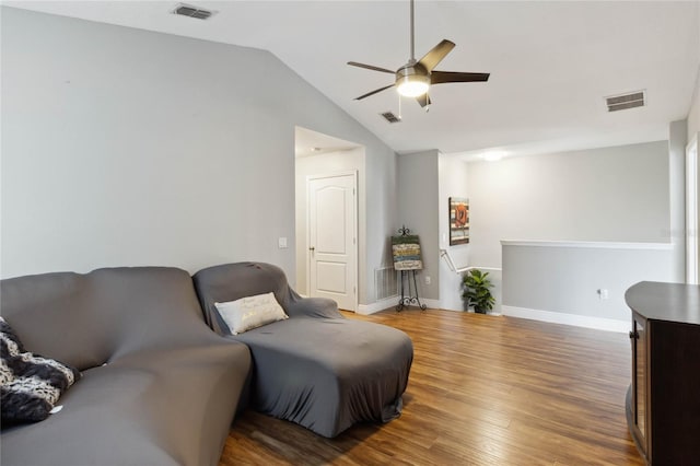 living area featuring lofted ceiling, ceiling fan, and wood-type flooring