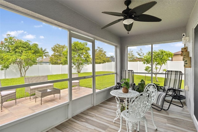 sunroom featuring ceiling fan