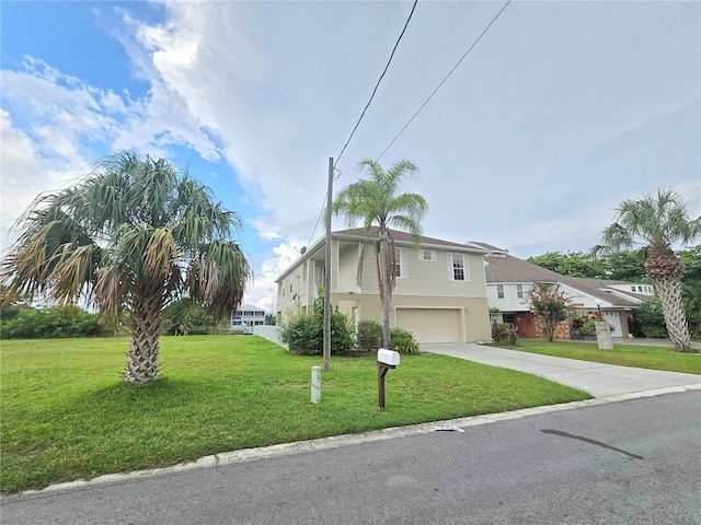 view of front of house with a front yard and a garage