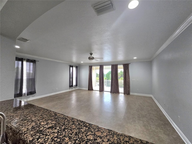 interior space with ceiling fan, ornamental molding, and a textured ceiling