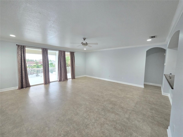 empty room featuring ceiling fan, crown molding, and a textured ceiling