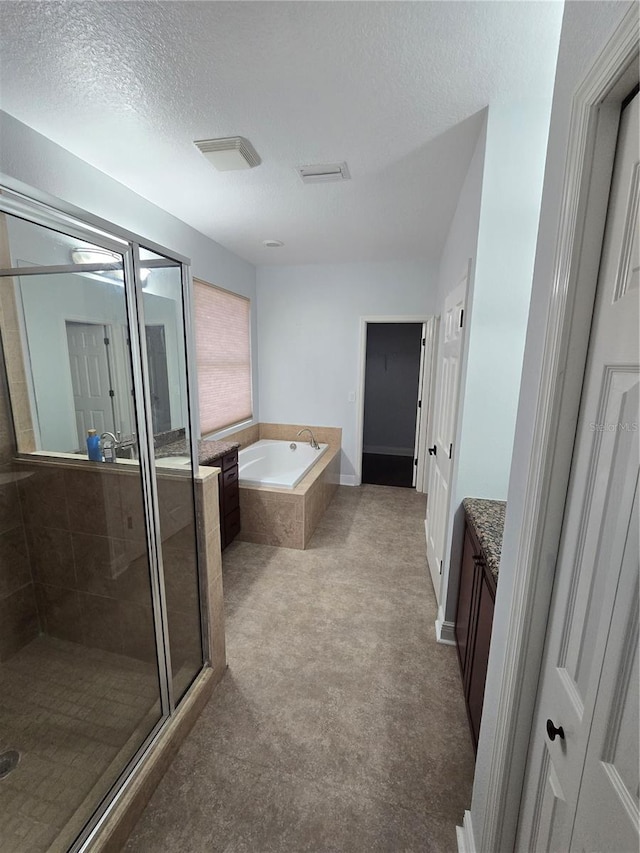 bathroom with separate shower and tub, a textured ceiling, and vanity